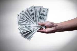 A person holding money for hiring office movers.