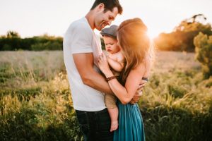 A couple hugging their child in one of the up-and-coming places in Philadelphia.